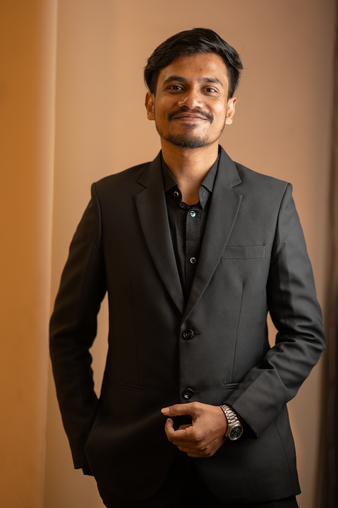 Portrait of Rafid Hossain wearing a beige suit